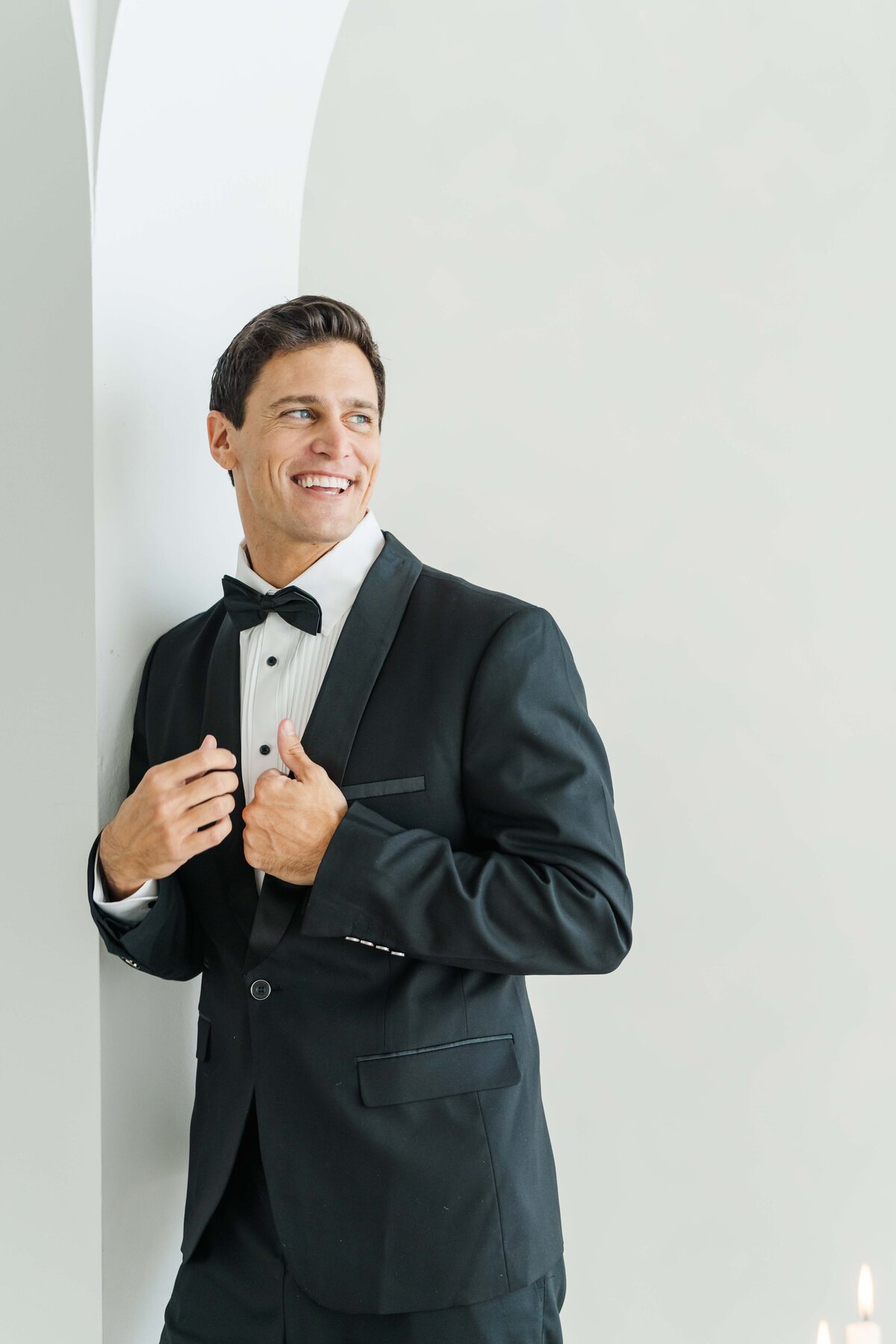 a groom smiling on his suit