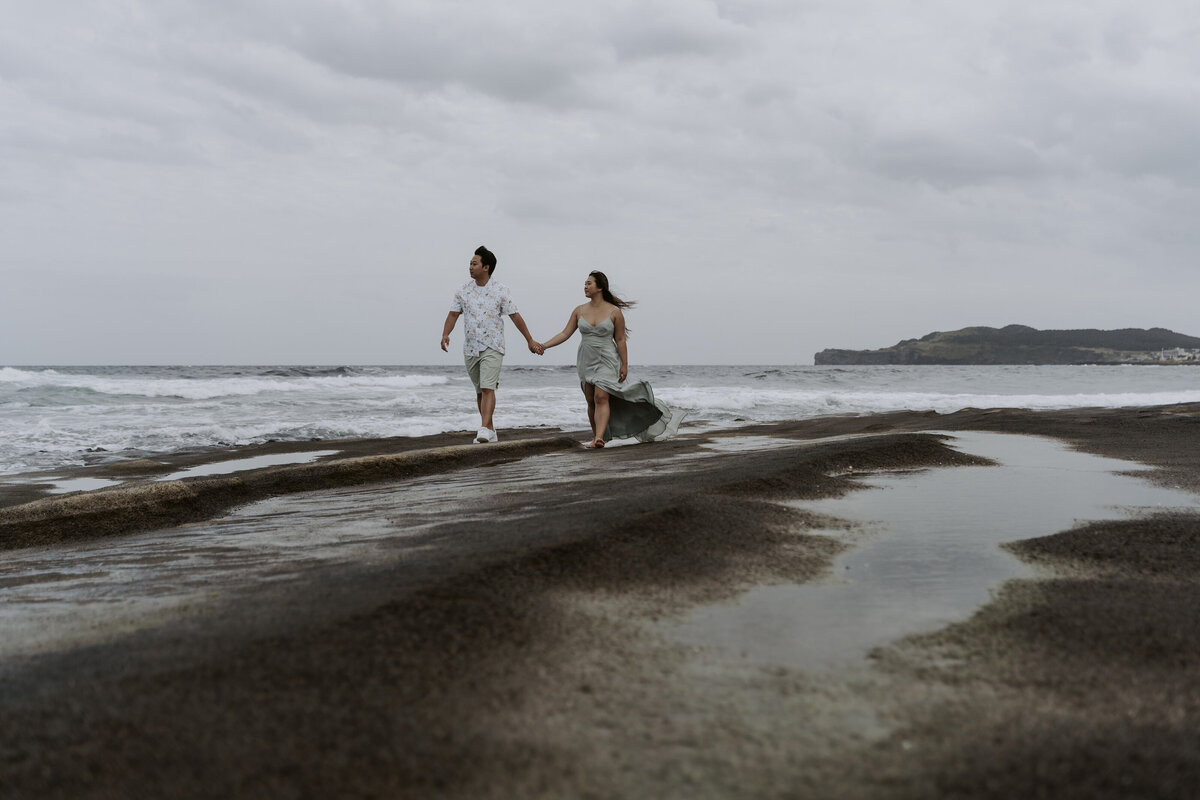 looking at the sea while holding hands in jeju island