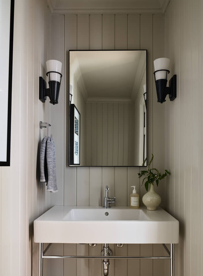 Light grey shiplap powder room by a Hingham kitchen and bath designer, combining modern design with classic texture for a timeless and inviting space.