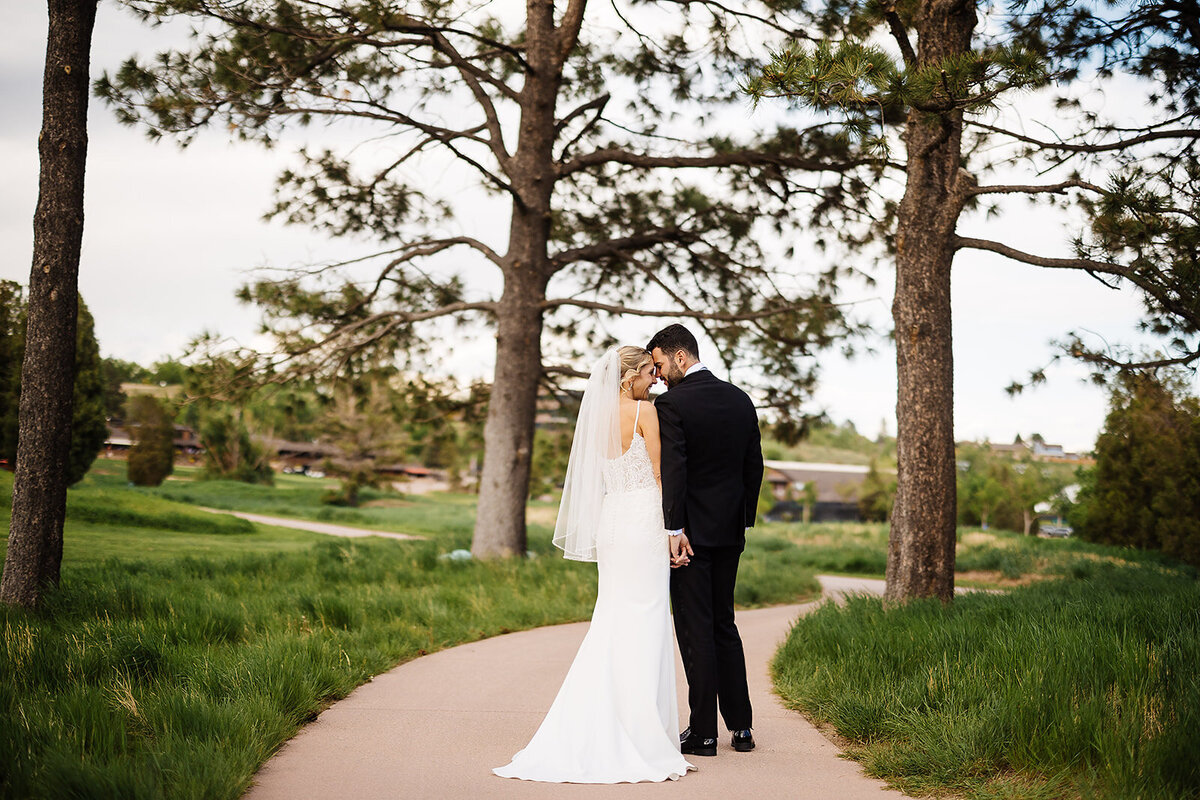 Bride and groom touch noses on their wedding day at Cheyenne Mountain Resort.