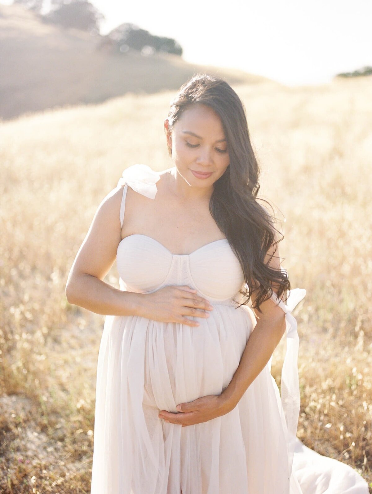 Pregnant woman in a tulle dress taken by one of the top San Francisco Maternity Photographers Laurel Smith.