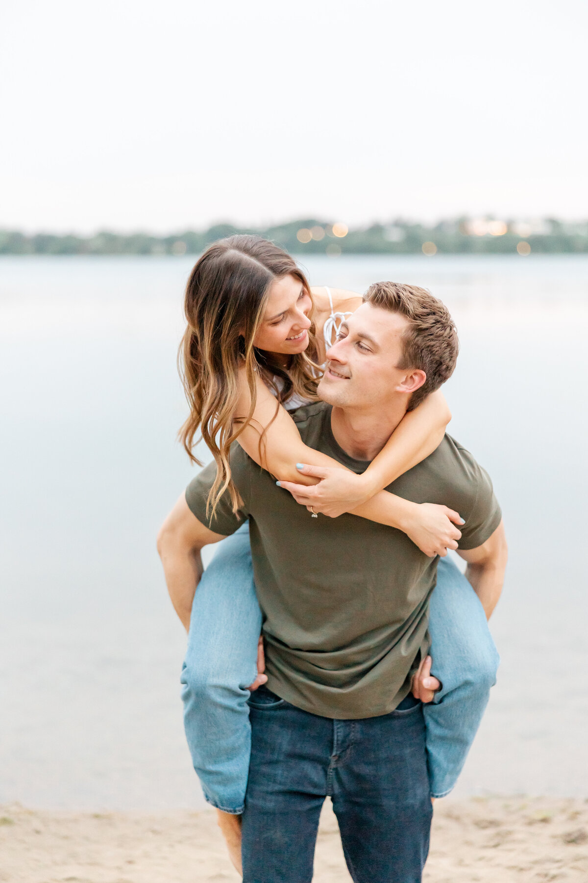 man piggy backing girl by wedding photographer in sarasota fl