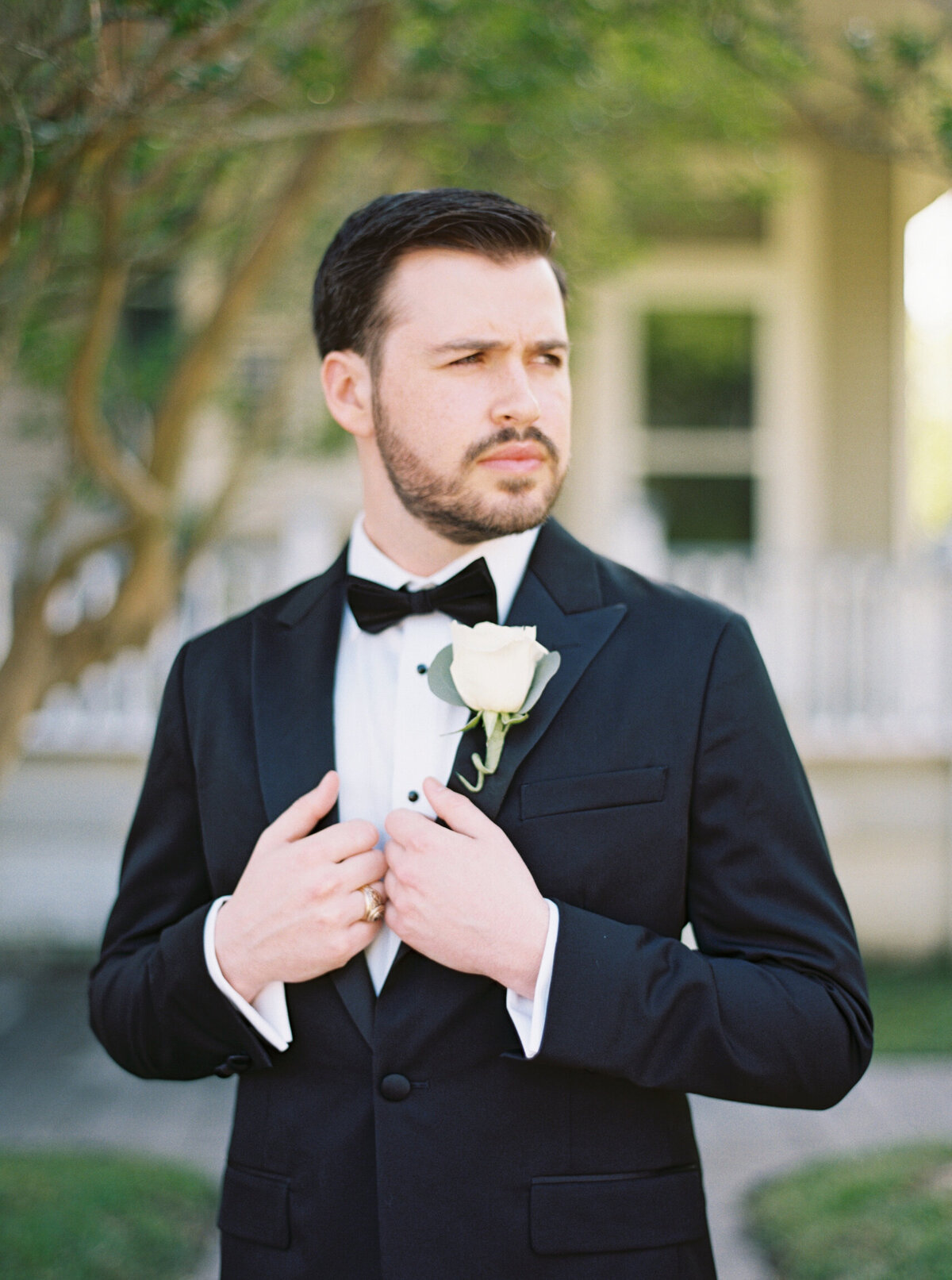 A refined groom’s portrait captured in Mandeville, LA, showcasing classic style and elegance on film by Morgan Alysse, Louisiana film photographer.