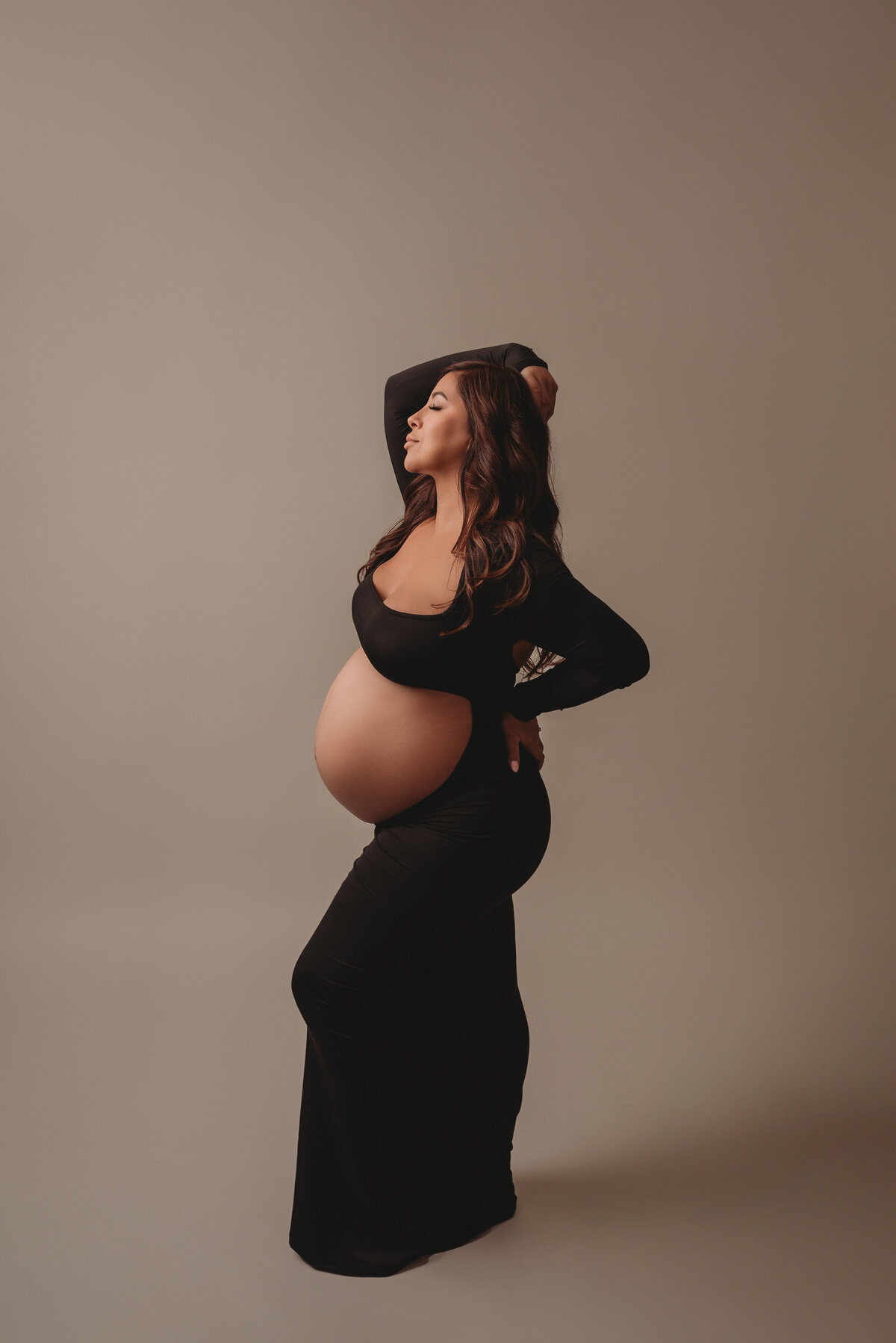 Maternity shoot with Atlanta, Georgia maternity photographer pregnant woman wearing black maternity gown