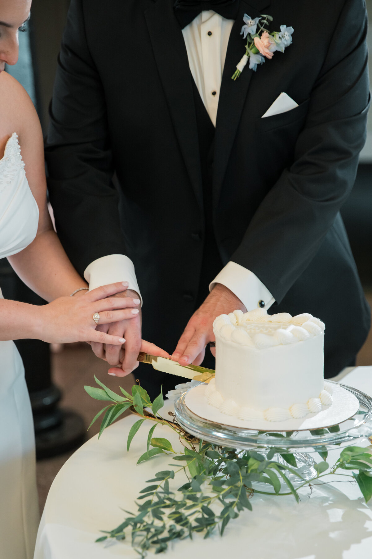 Bristol Train Station Wedding | closeup of bride and groom cutting a vintage-inspired cake