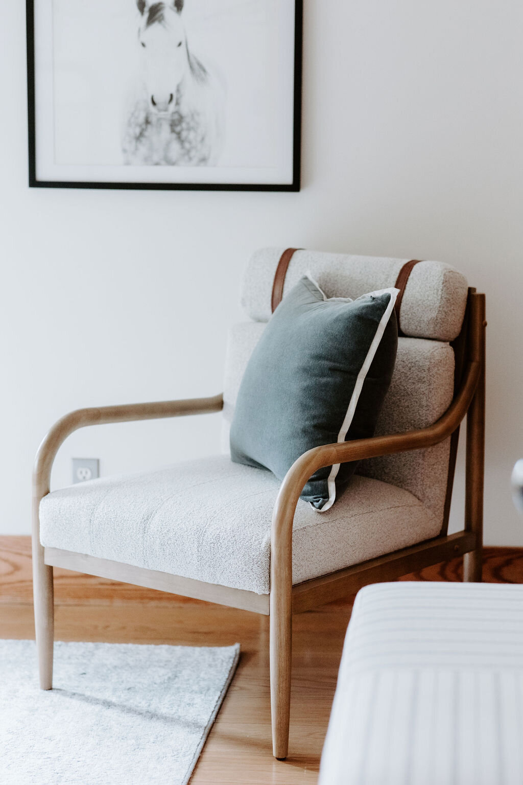 Hearth and Hand at Target boucle chair with steel blue velvet pillow by West Elm in the primary suite of the Modern Farmhouse overnight accommodations at Willowbrook wedding venue