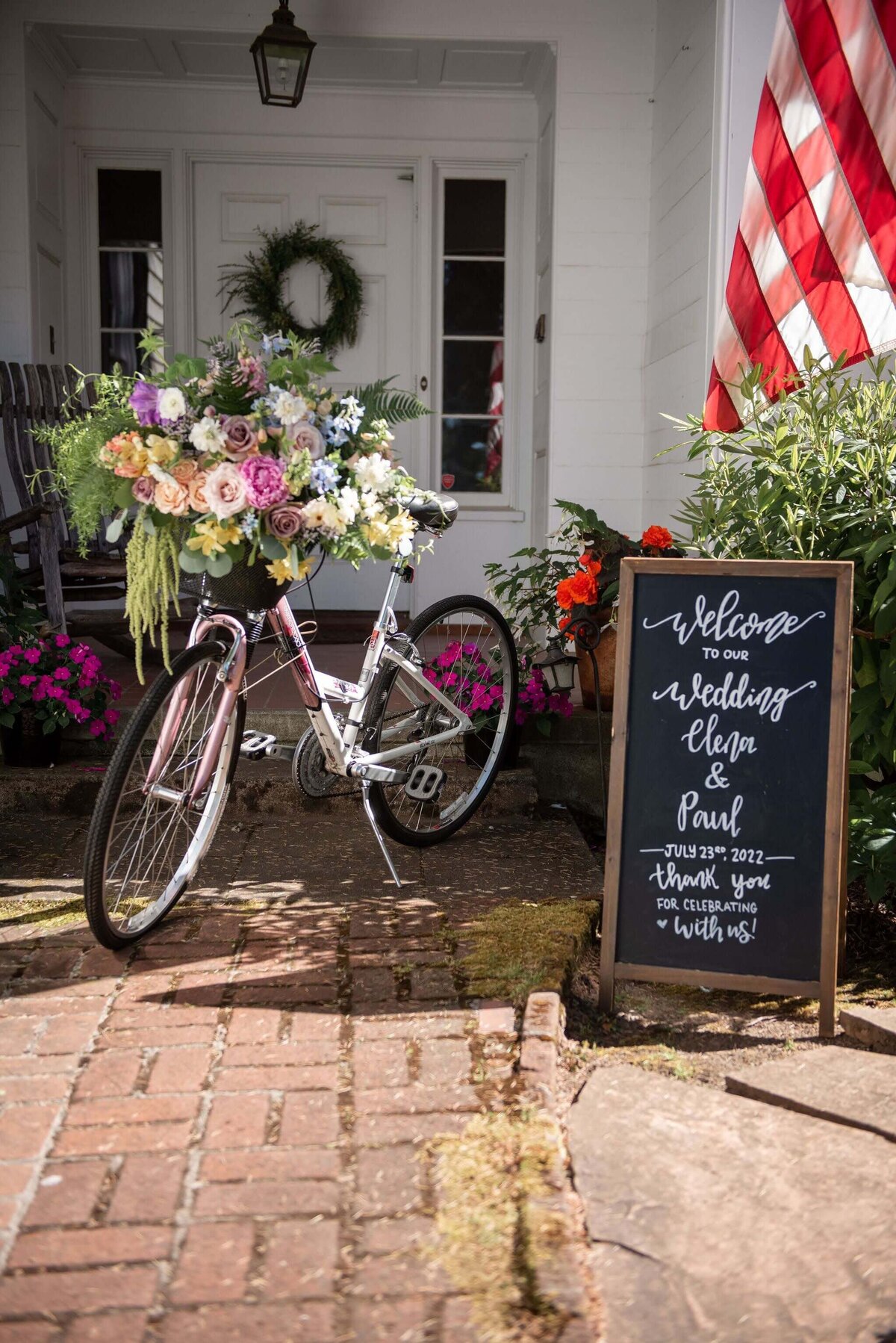 Bicycle with floral arrangement welcomes guests to a wedding.