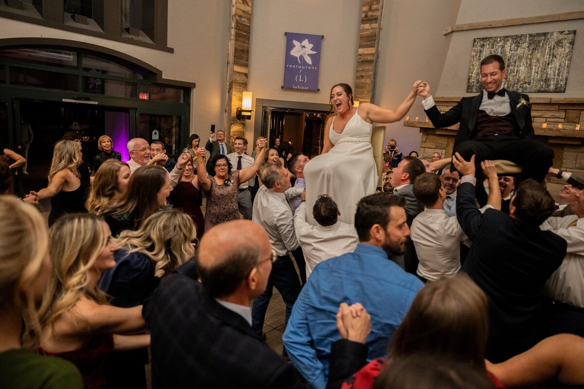 Bride and Groom with their guests dancing the Hora at their wedding reception.