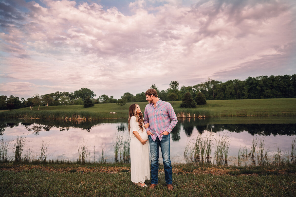 pregnant women and partner at sunset