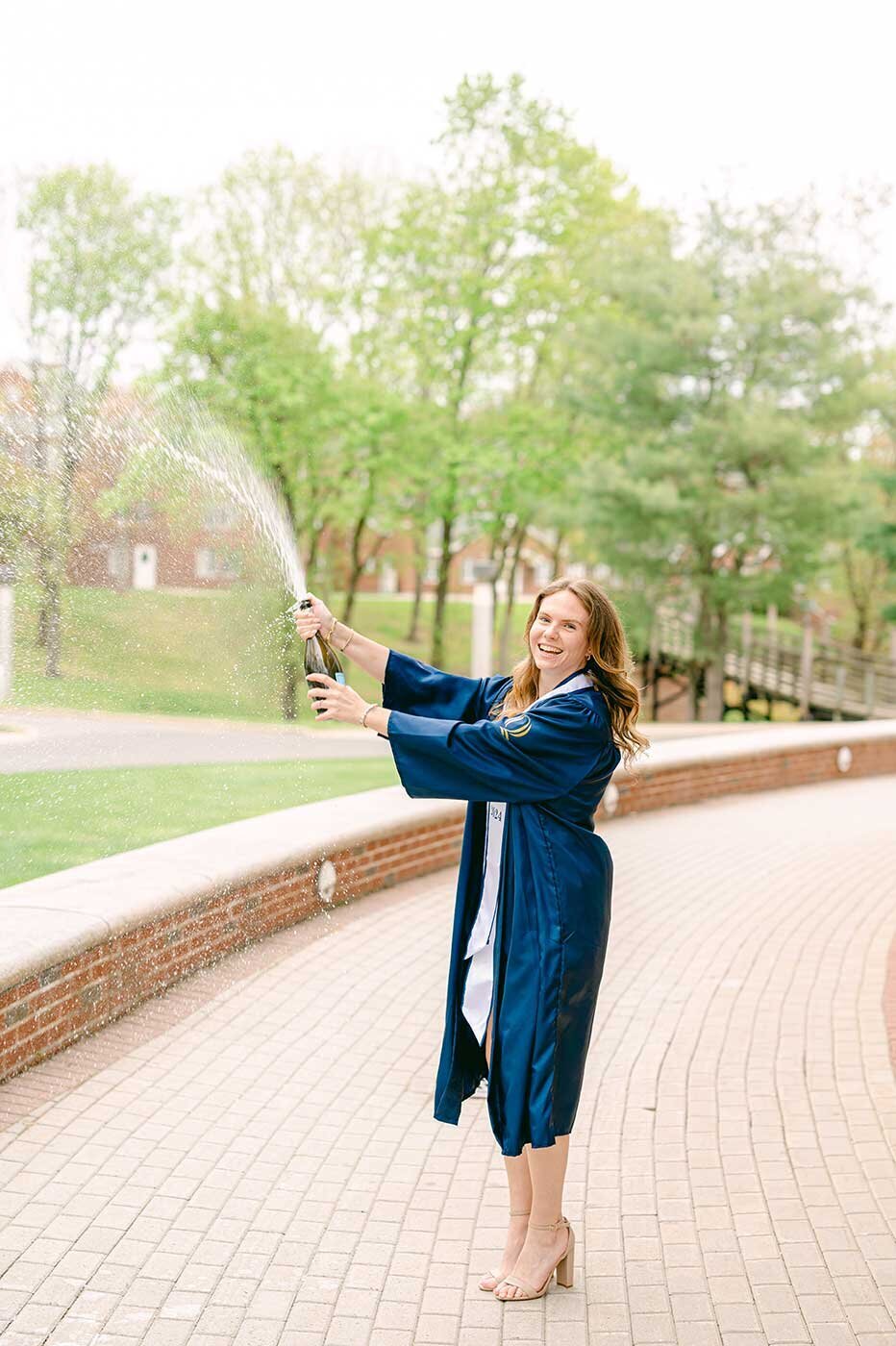 College graduation tradition pop champagne bottle