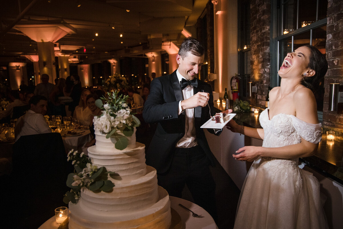 A couple cuts their cake at a Tribeca Rooftop wedding in Manhattan
