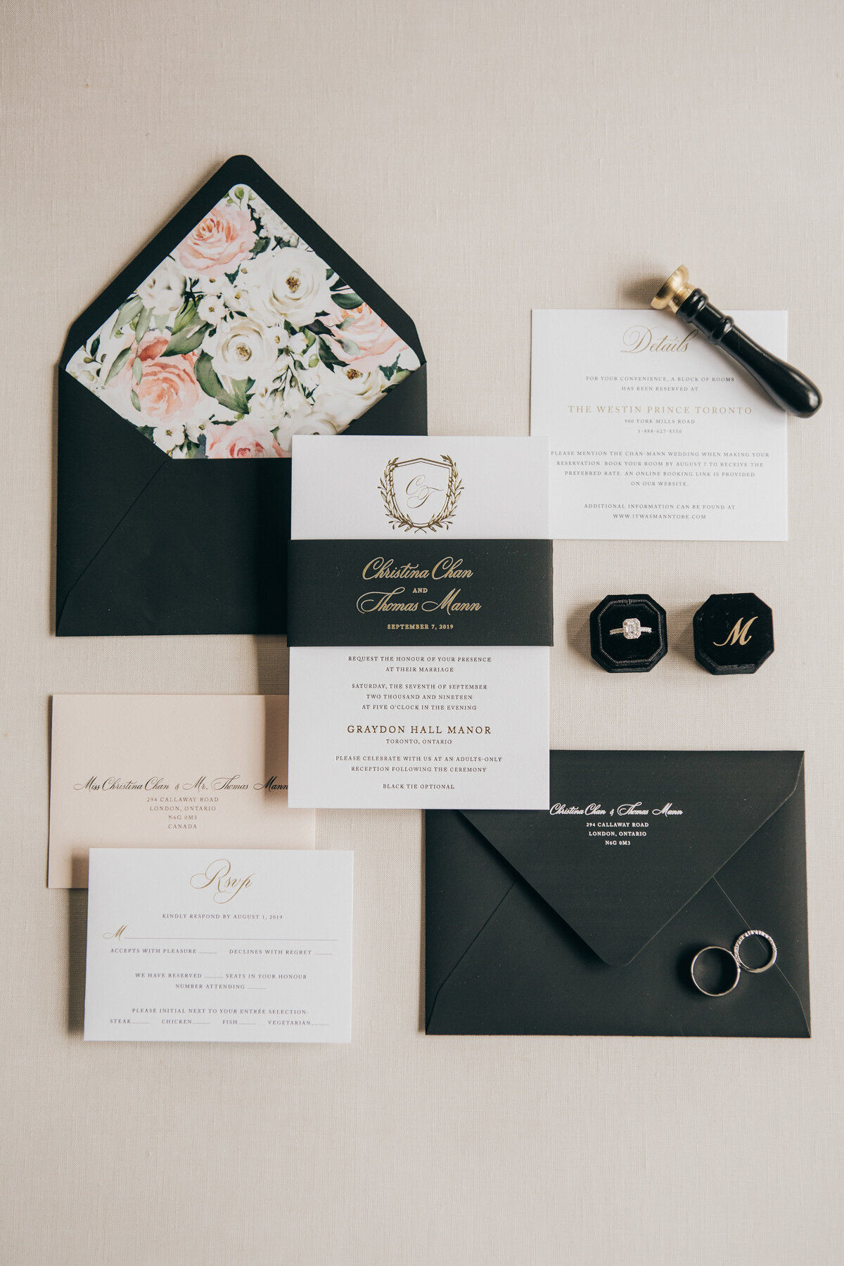 Detail shot of luxurious black and gold wedding invitations and wedding bands