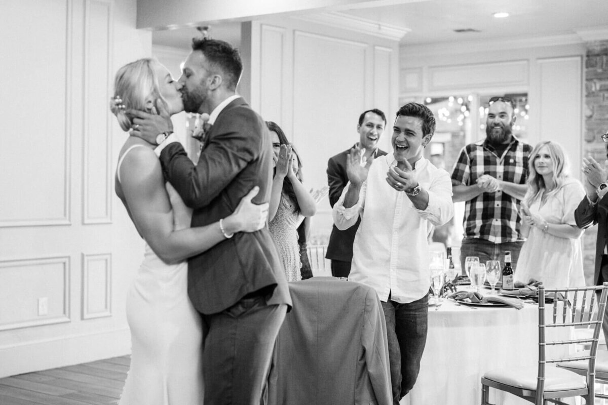 guests-cheering-and-clapping-for-kissing-couple