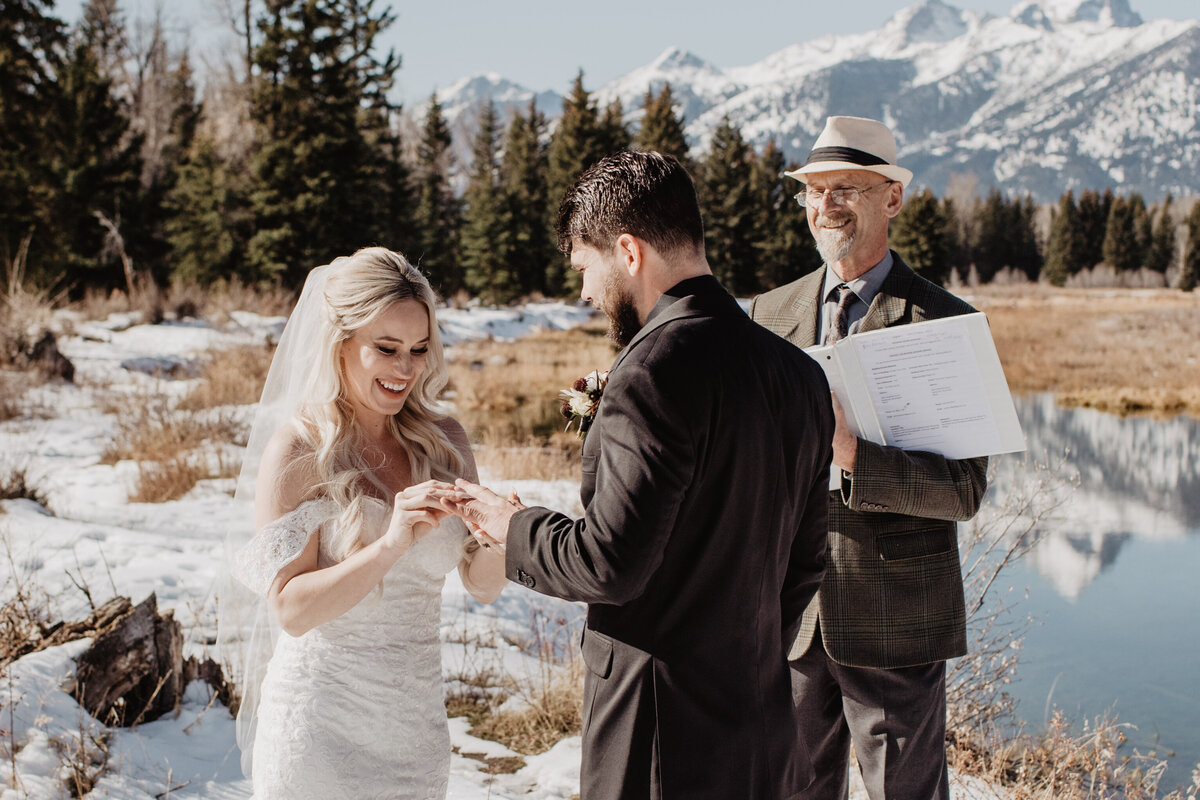 Jackson Hole Photographers capture bride putting ring on groom's finger