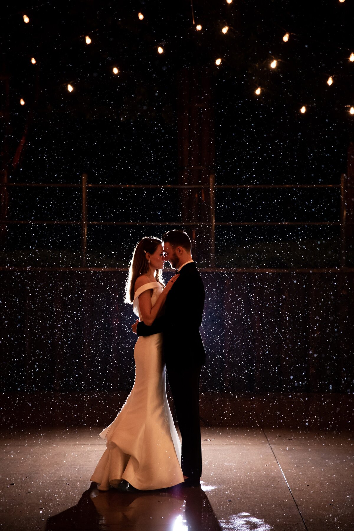 Bride and groom dance in the rain on their wedding night at Spruce Mountain Ranch.