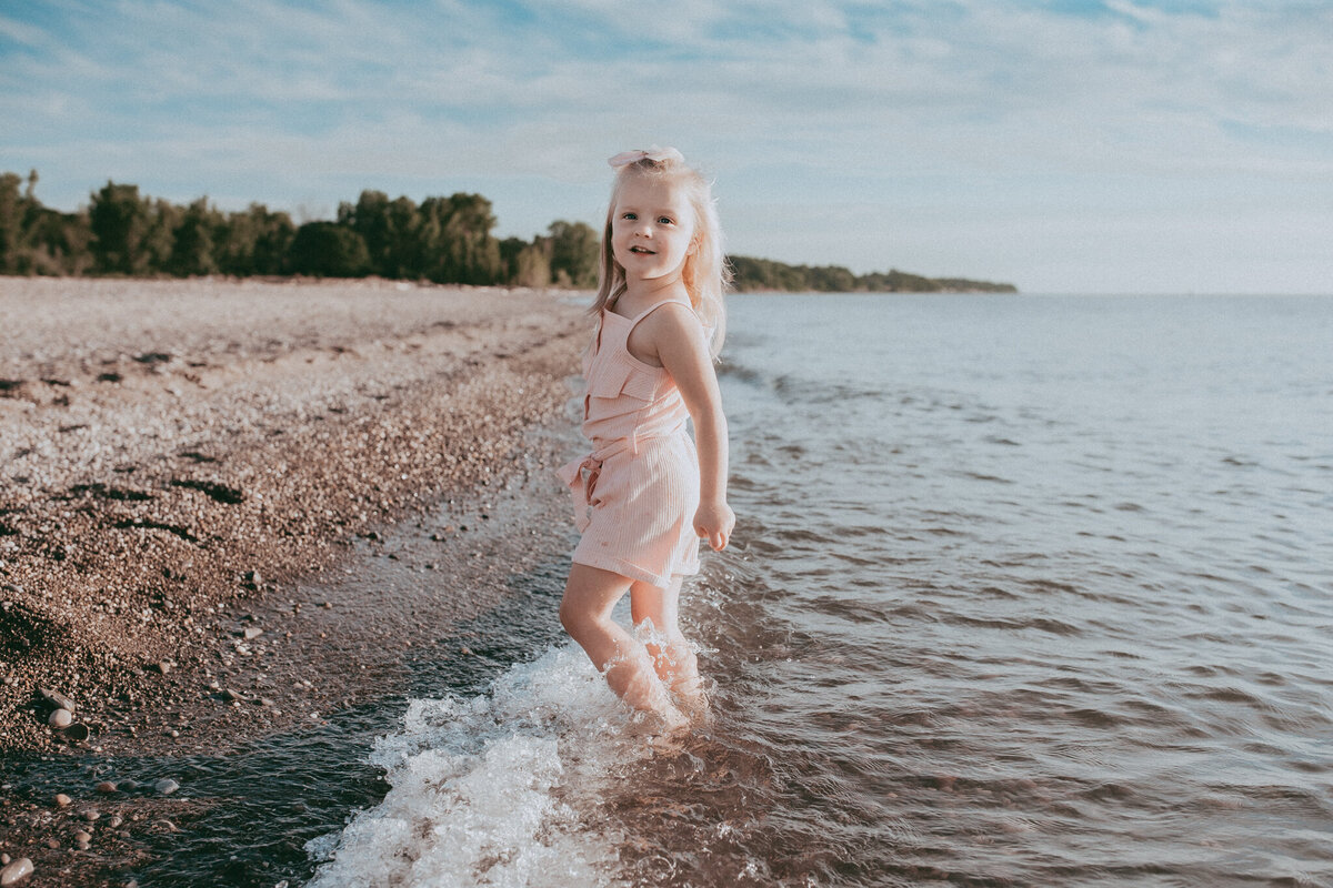 little girl playing on the beach