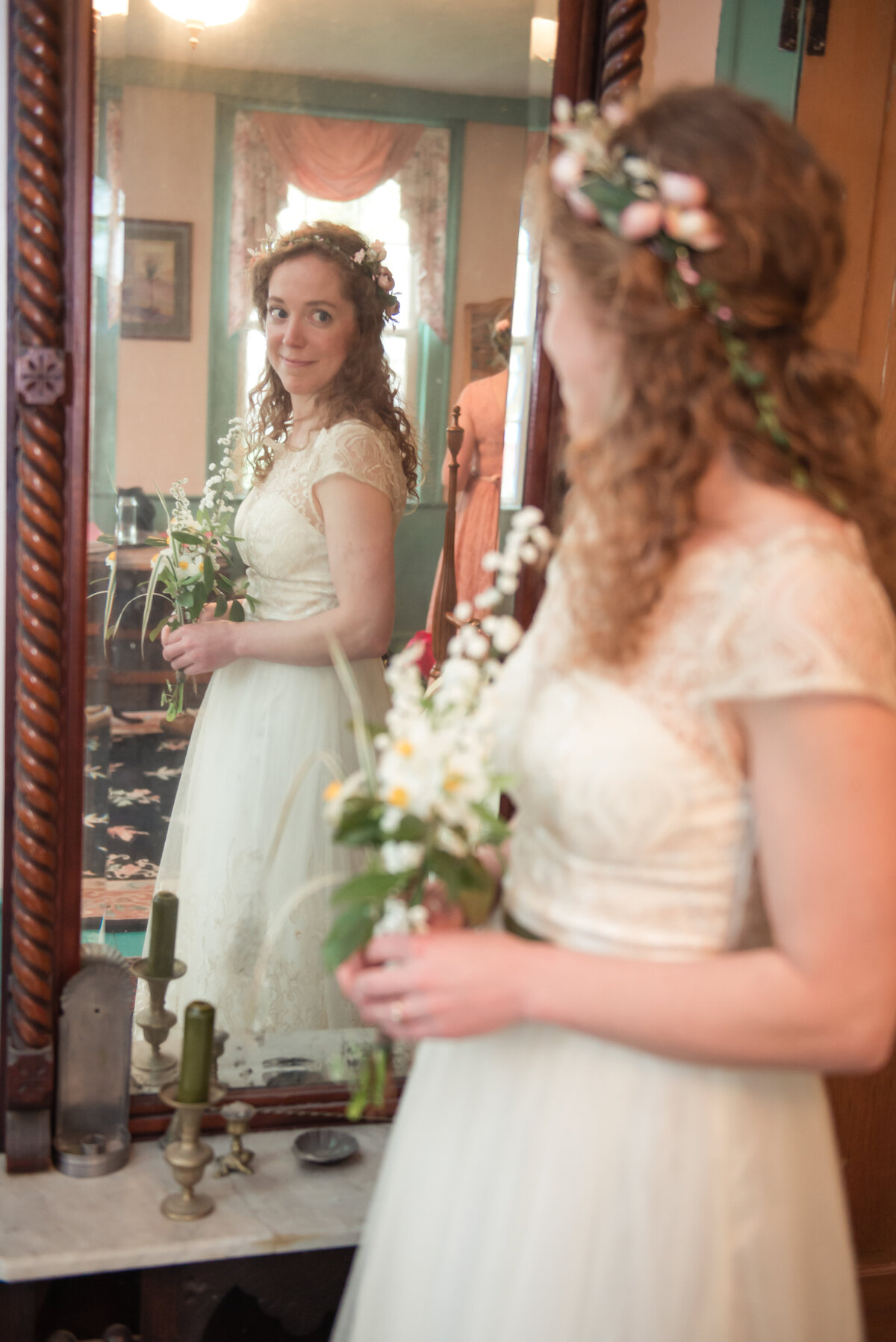 Bride looking in mirror on wedding day