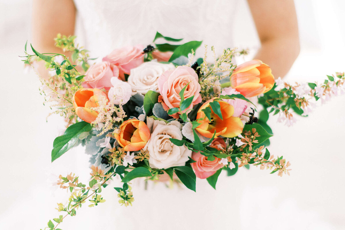 Summer bridal bouquet with blush, pink, and coral colors
