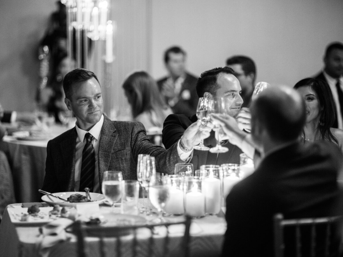 A moment of camaraderie captured as friends raise glasses in a toast, symbolizing celebration, memories, and the bonds formed during shared meals and joyous gatherings.