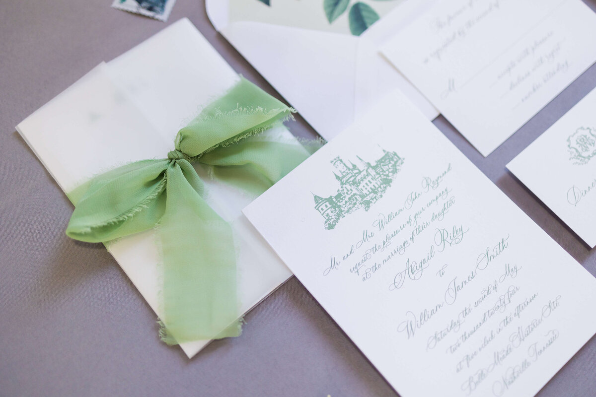 Wedding invitations and green ribbon