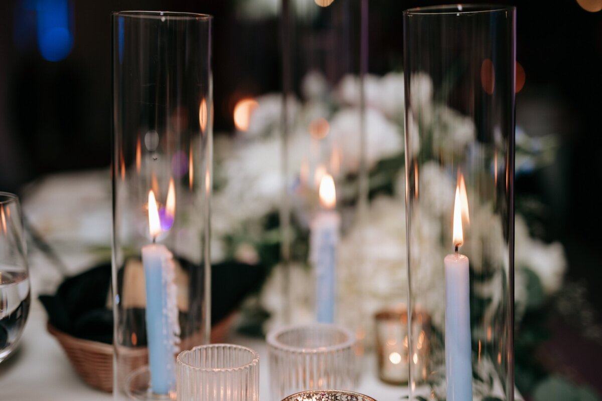 Upclose photo fo the candles inside of glasses on the Bride and Grooms table at the Reception.