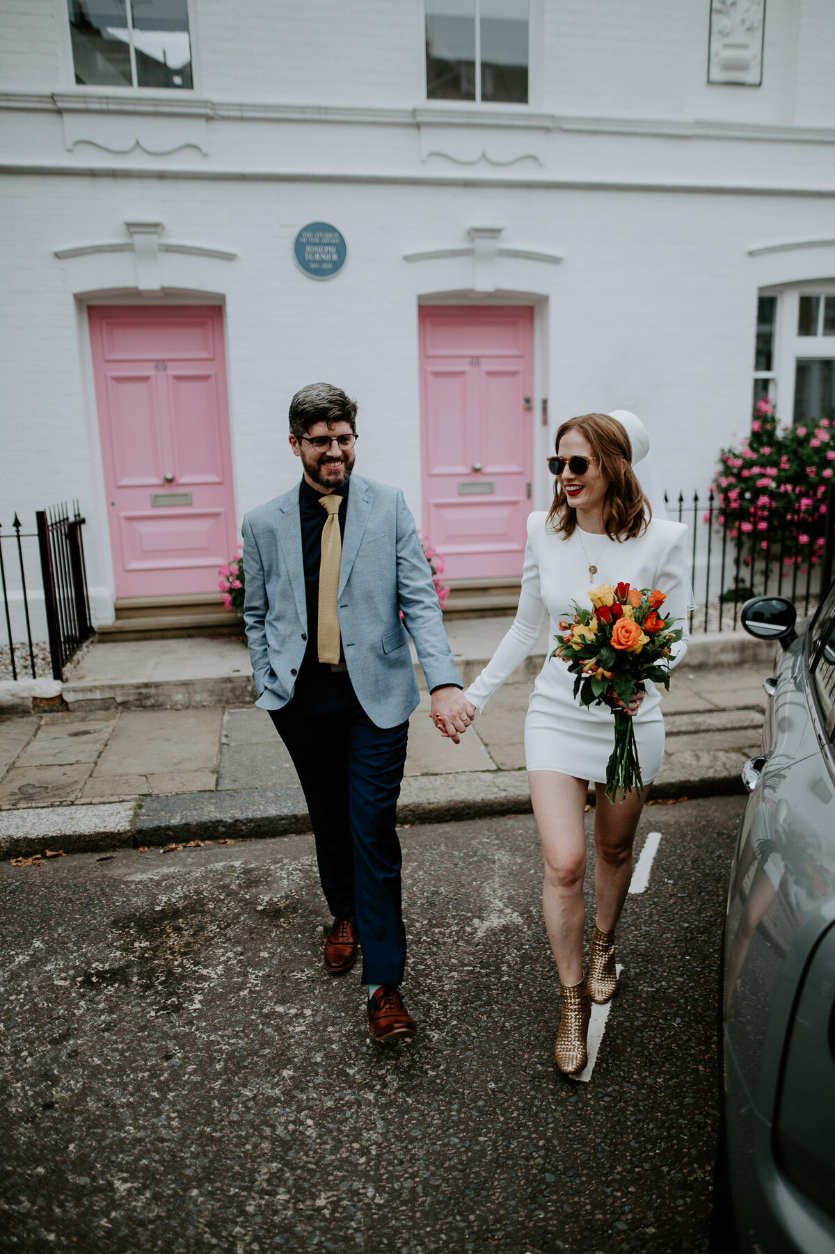 I took this bride and groom to the famous pink doors at Turner Studios in Chelsea, London. The bride is wearing a short Neta Porter dress and has a vintage hat, he bouquet was picked up that morning from the Chelsea Flower Show.