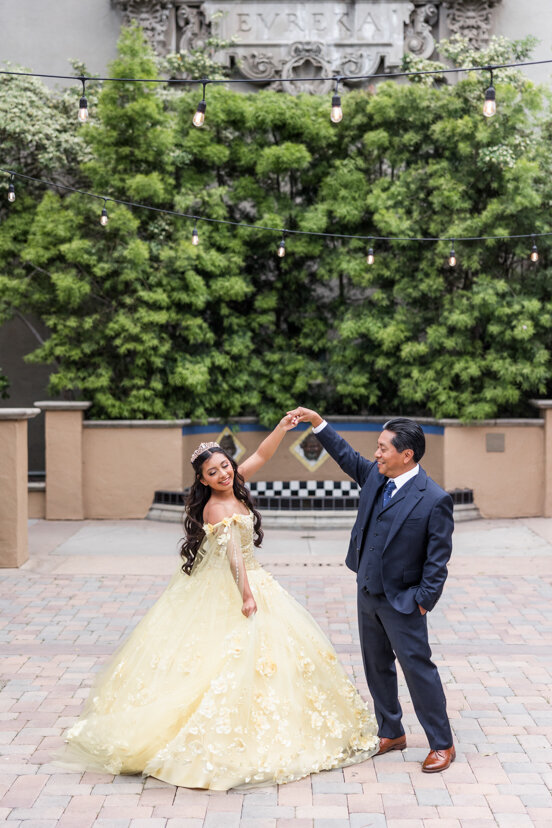 father-twirling-daughter-yellow-dress