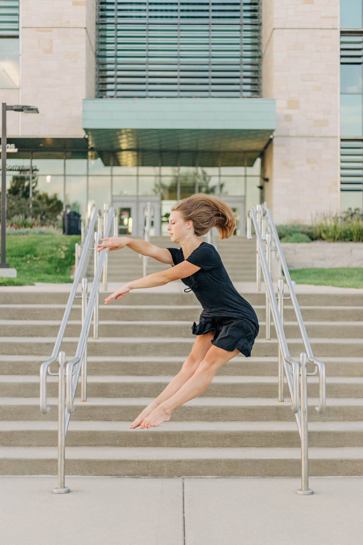 girl jumping in the air by a stairway
