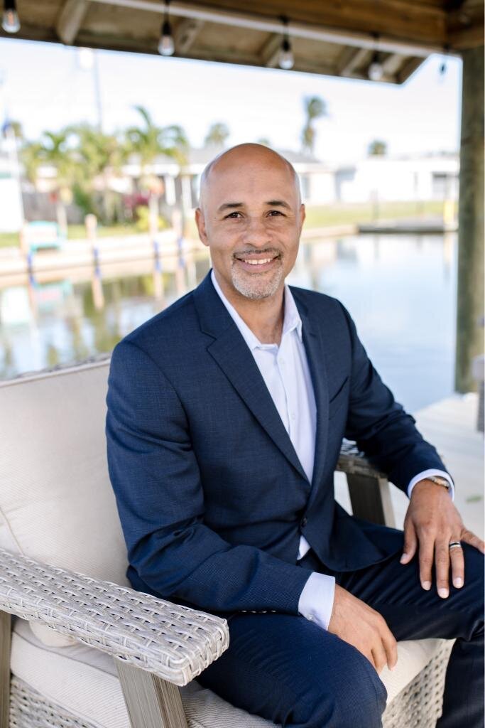 Damian sitting outside, enjoying a relaxed and natural moment ideal for .personal branding photoshoot