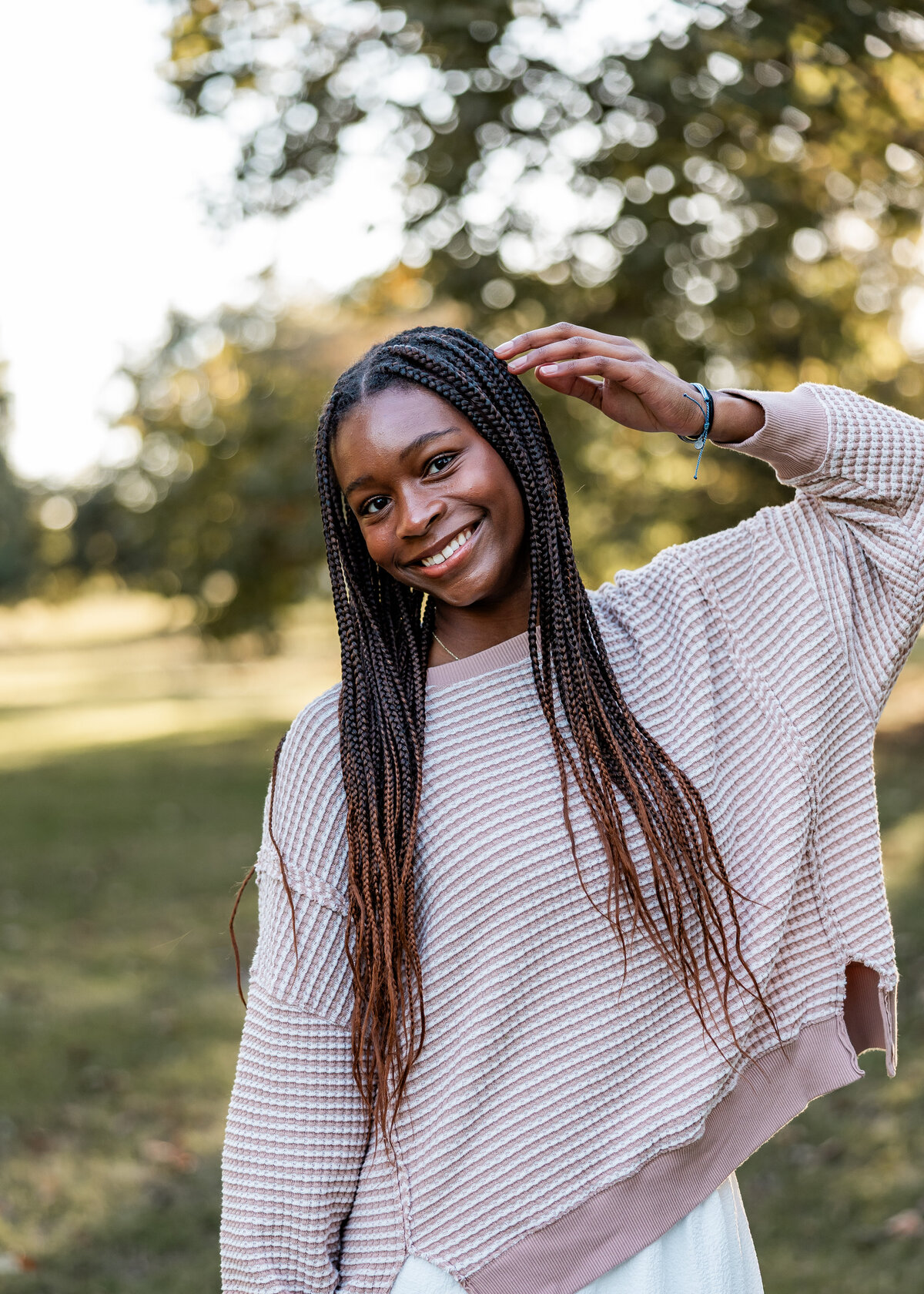 A young black woman wearing cozy fall clothes in Riverside Park in Wichita, Kansas