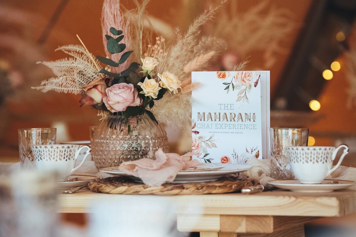 Maharani Chai table setting with rose and pampas grass flower arrangement