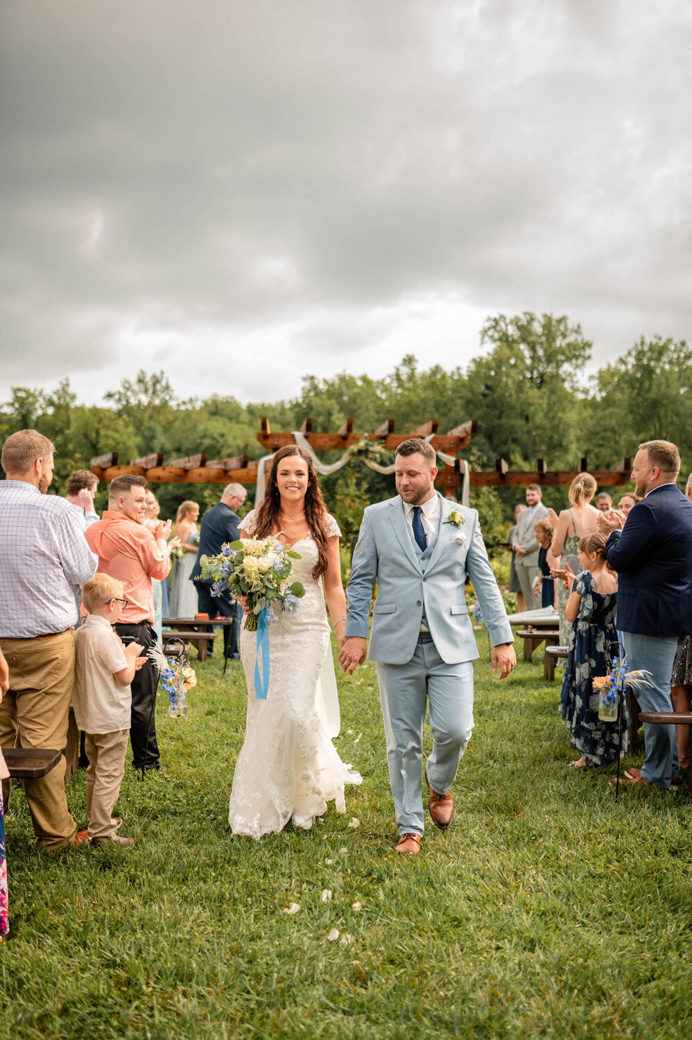 Bride and groom walking down the aisle after ceremony at the pergola