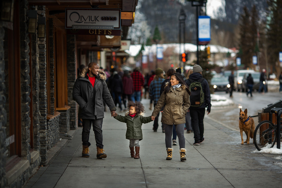 Beautiful family walking the streets of Banff in the winter