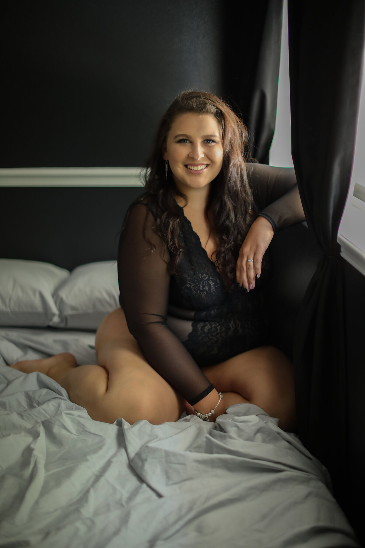 Casey Heather boudoir-bradenton-sarasota-longboat key-florida-dark and moody-sexy-lingerie-curvy-black bodysuit-smile
