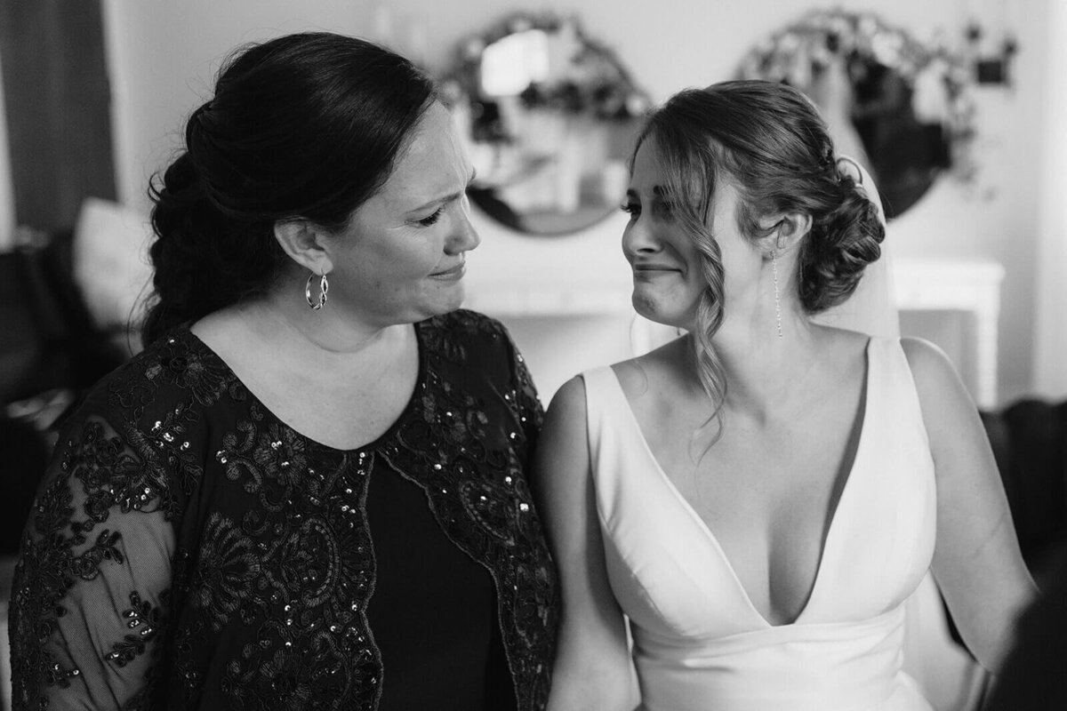 Mother and bride looking at each other before Oswego wedding, NY
