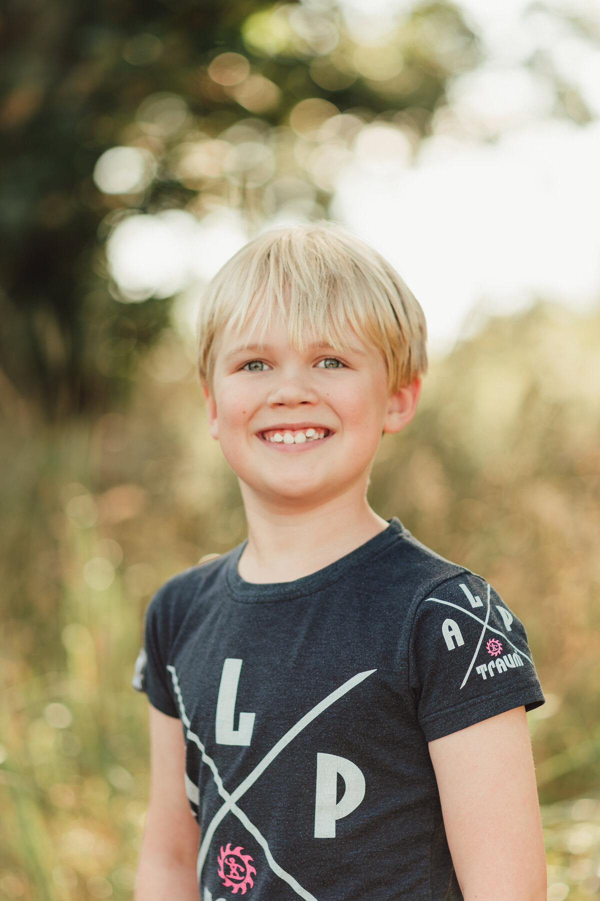 A student walking down a scenic path surrounded by trees, perfect for outdoor school portraits.