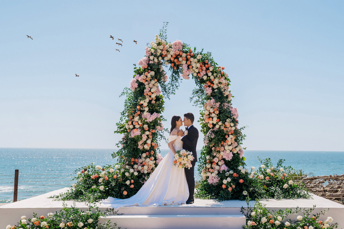 6510af4000c845f30285a795_Ocean Wedding Lush Floral Arch Beach Alila Marea