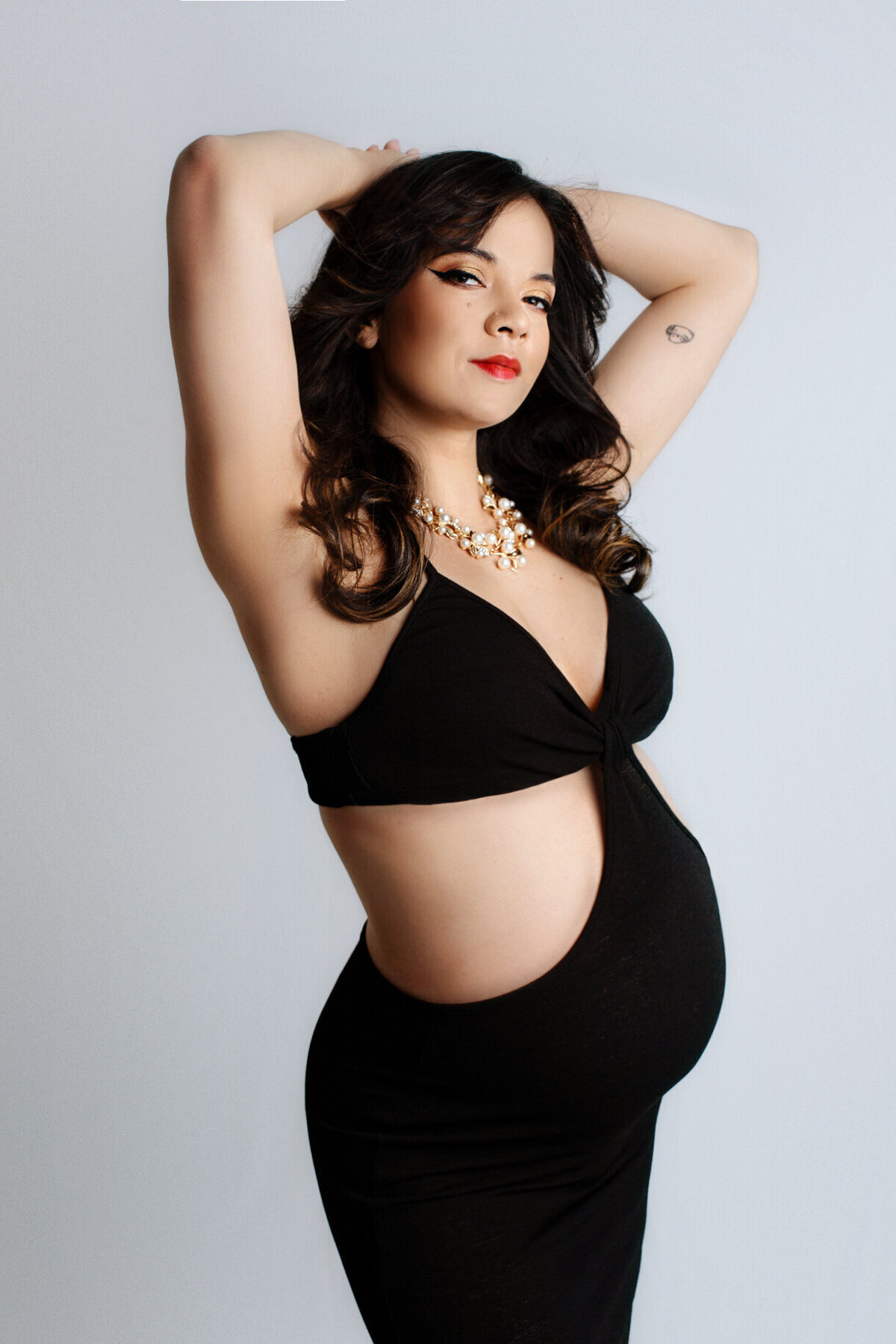 stunning pregnant model in skimpy black dress captured by hamilton maternity photographer, White Orchid Photography