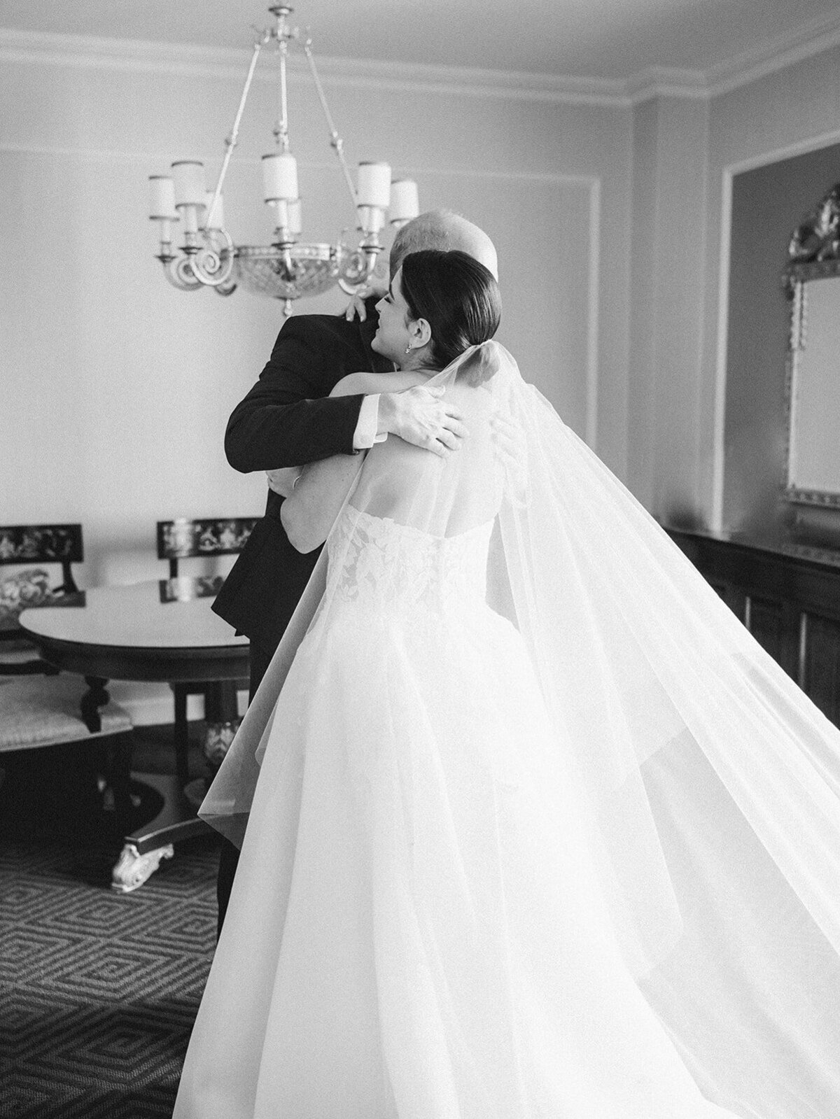 Father hugs bride during first look