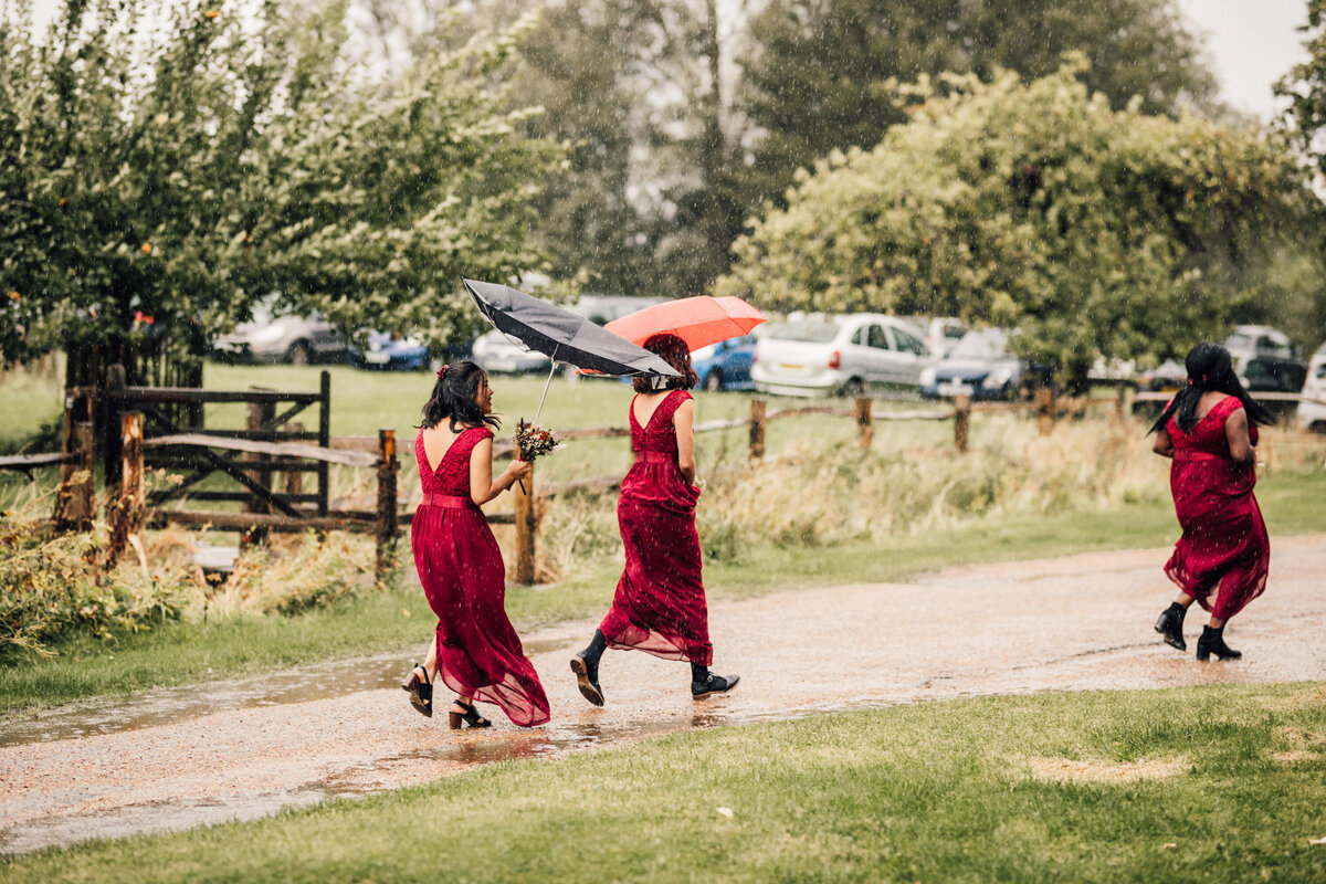 Bridesmaids in red dresses walking outdoors