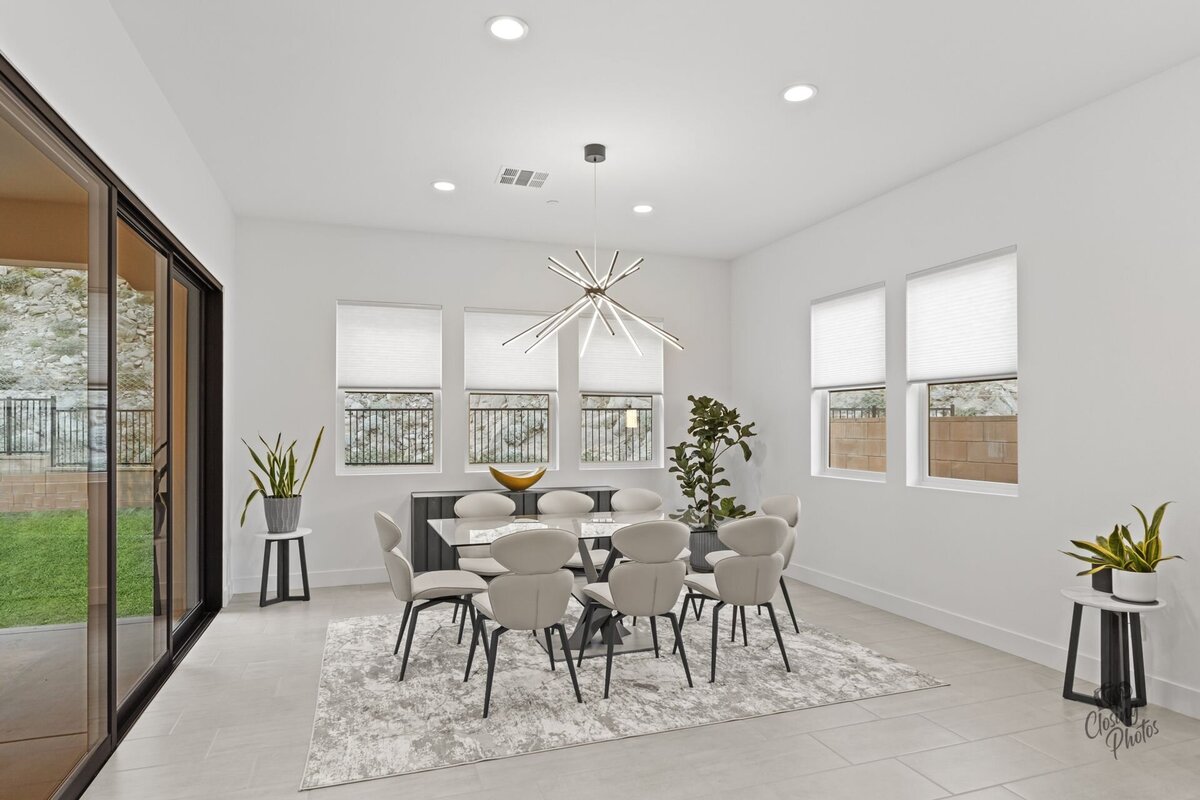 Modern and minimal dining room with a view outside sliding doors to the backyard.