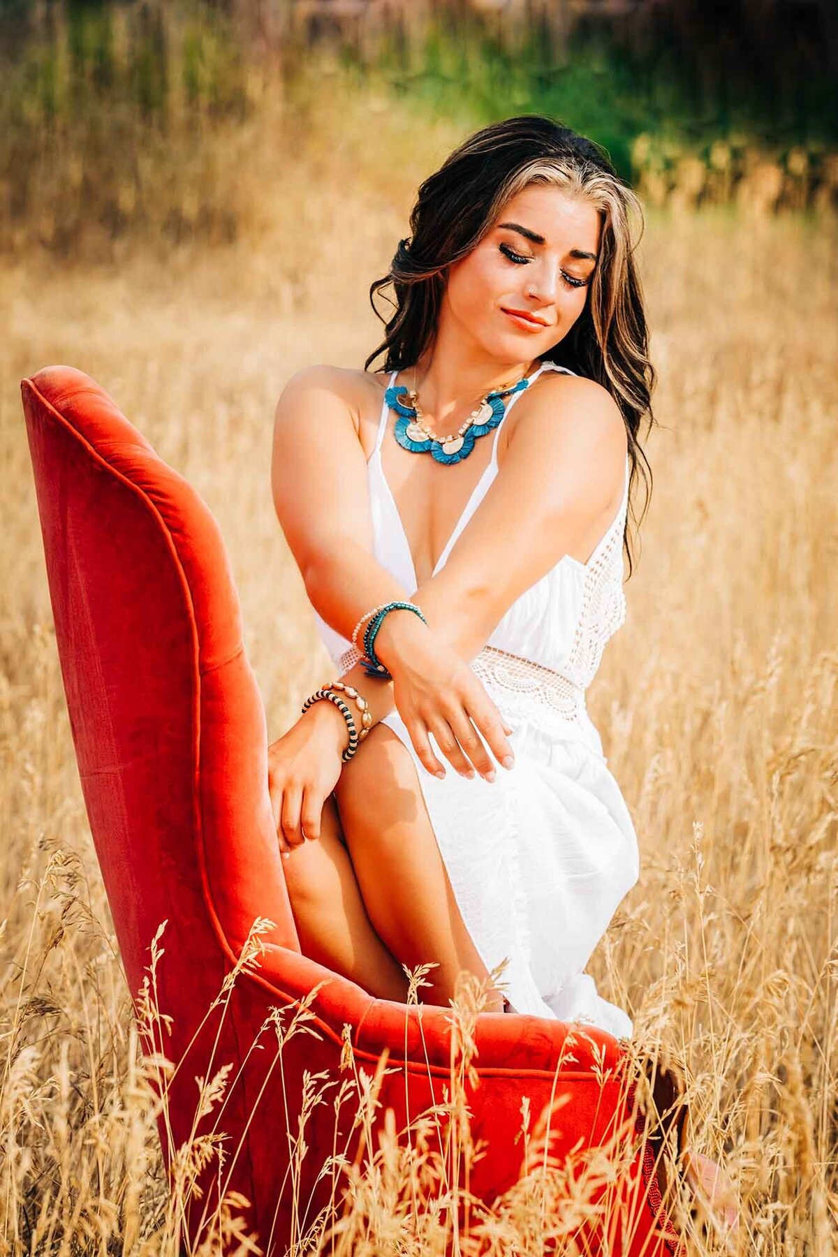 Missoula senior picture of girl sitting on orange chair in field