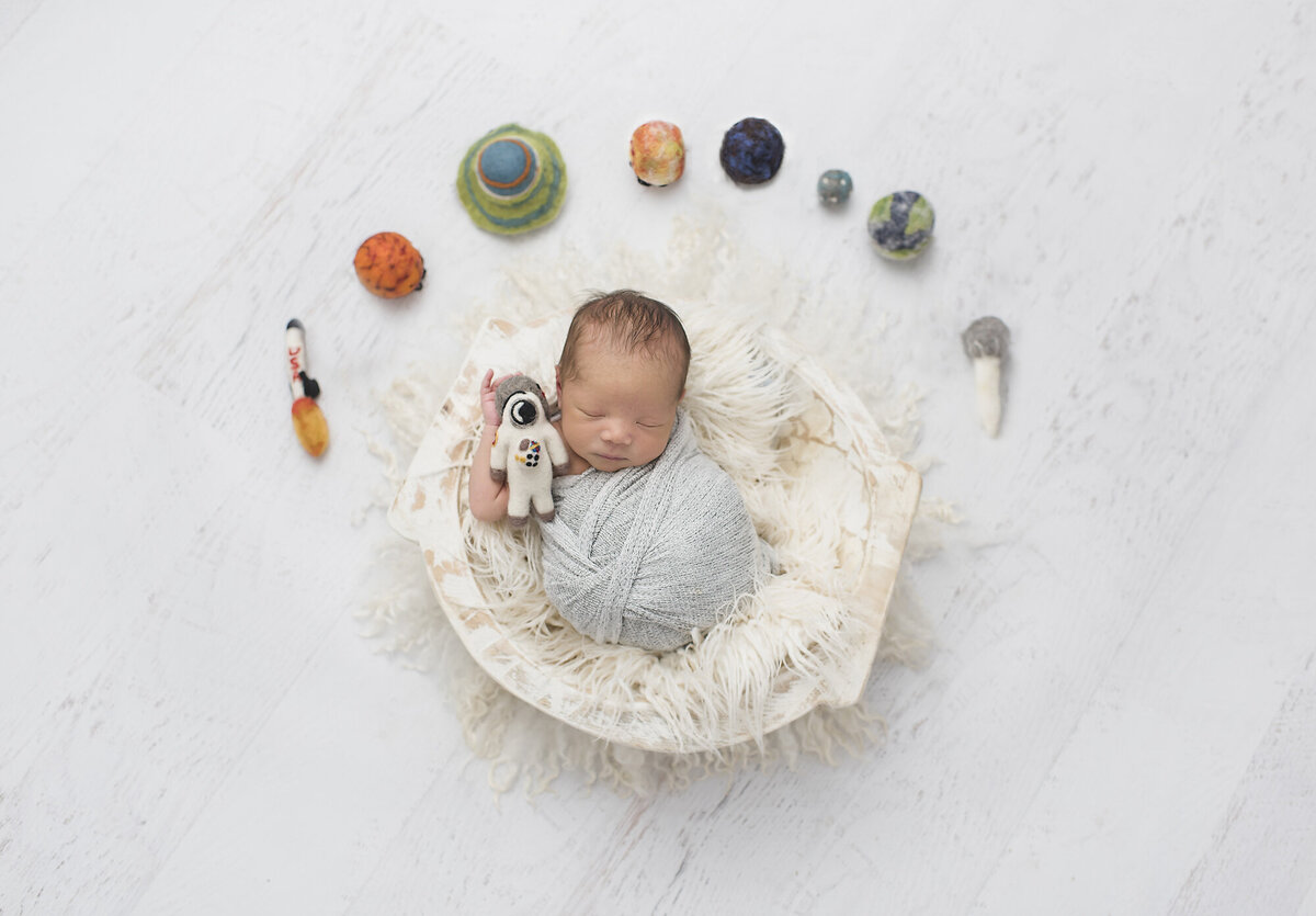 a newborn photography session that is spaced themed