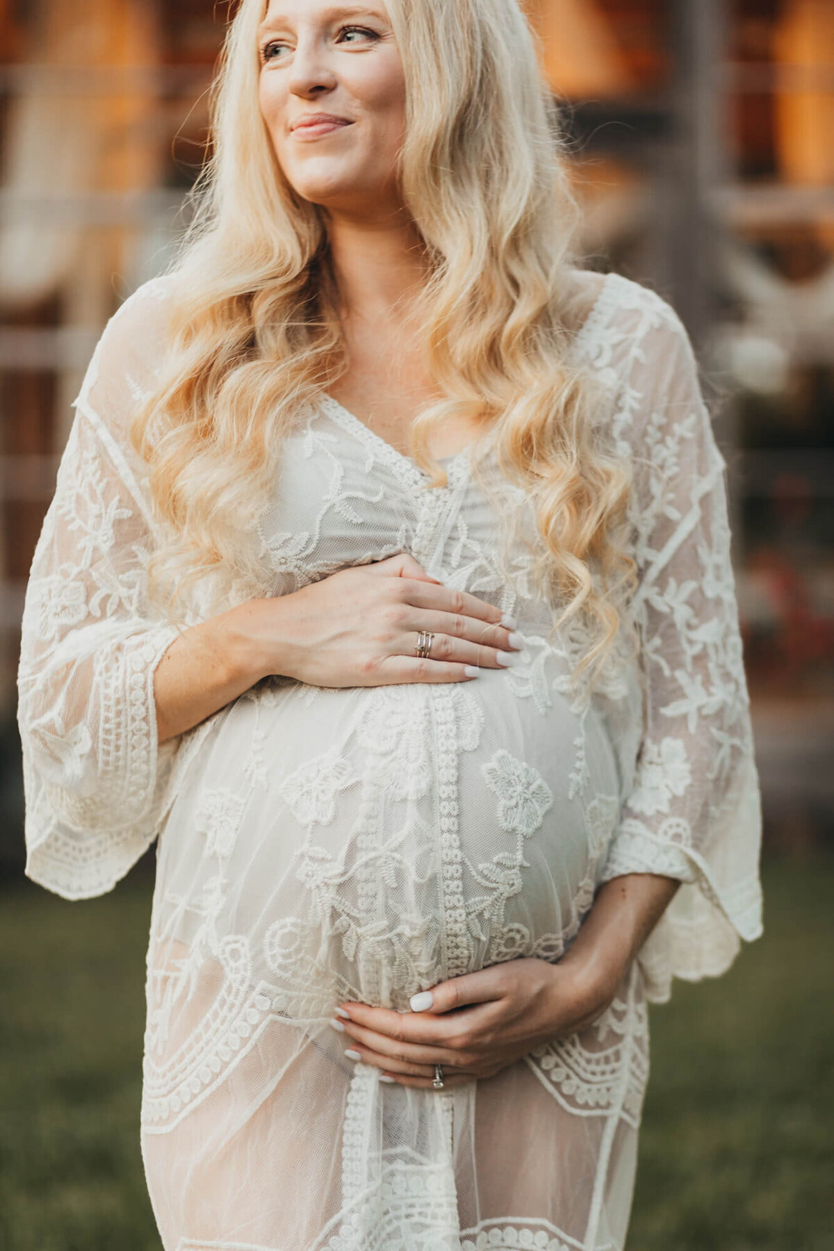 pretty mom wears a kimono while holding her belly during photos for ally's photography.