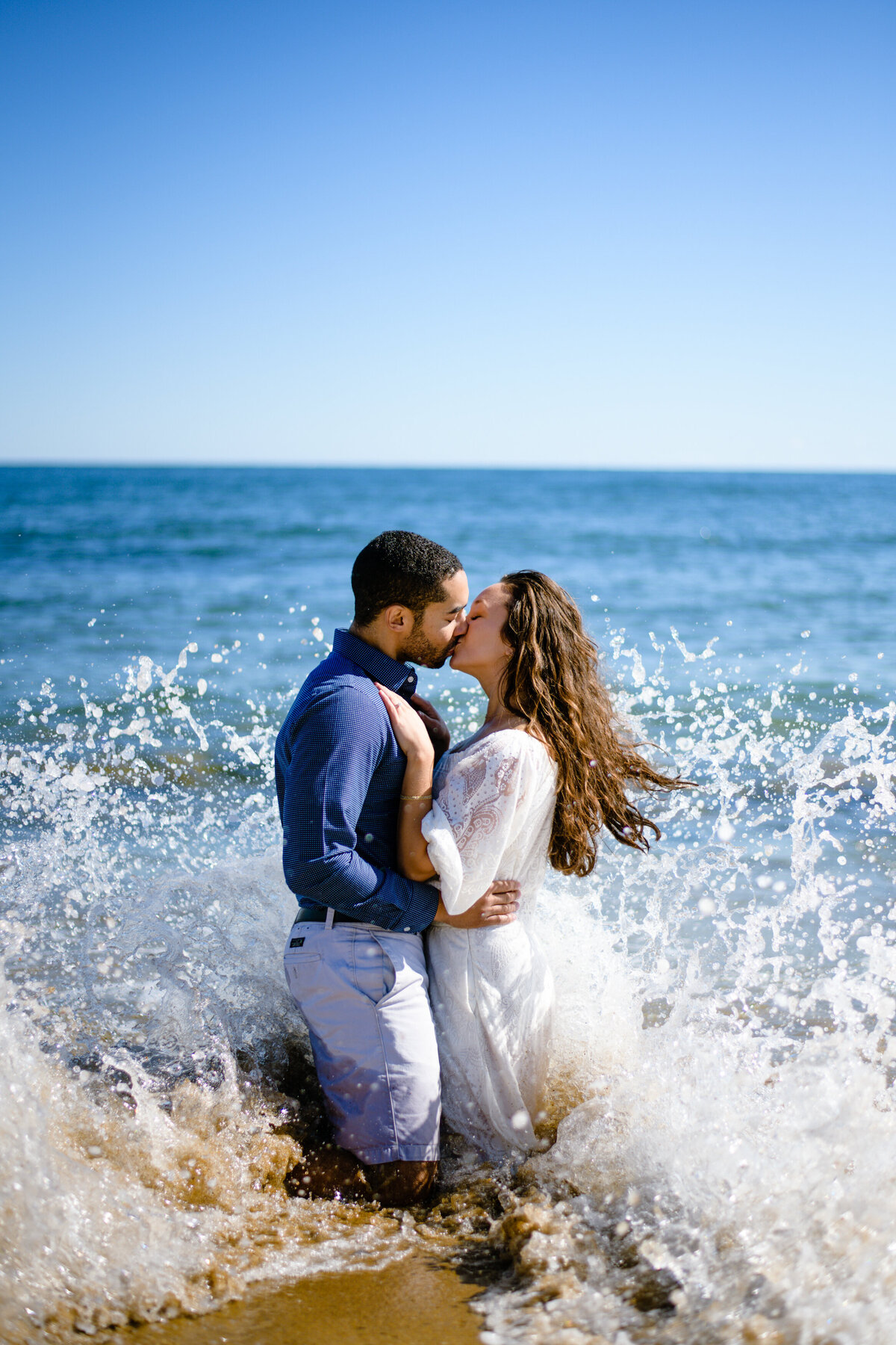 MA beach wave photography session for engaged couple