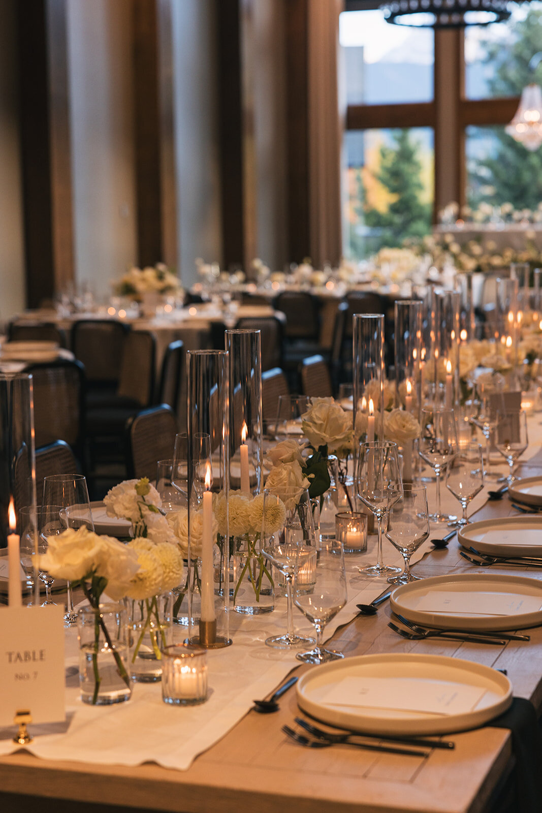 Rectangular wedding reception table with bud vases at the Malcolm Hotel Canmore