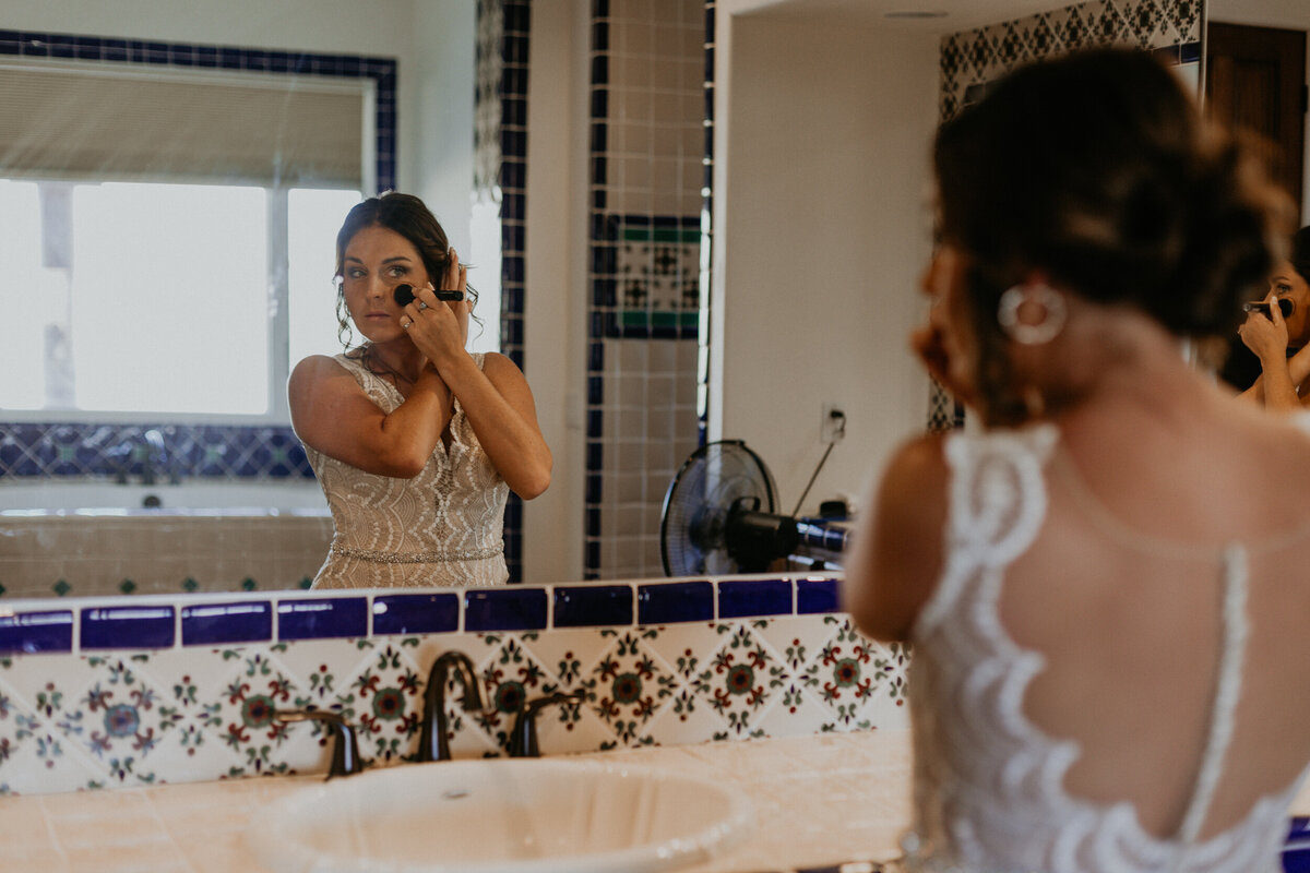 bride getting ready in a southwestern styles bathroom