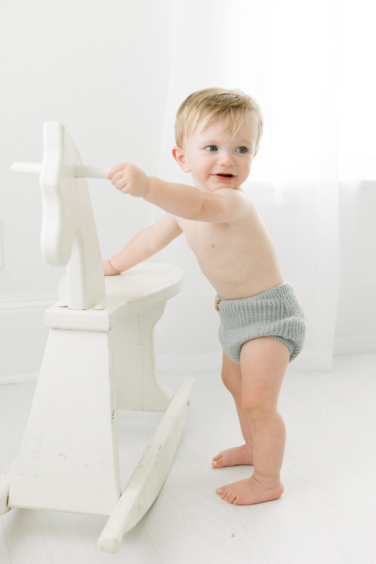 a toddler playing with a rocking horse