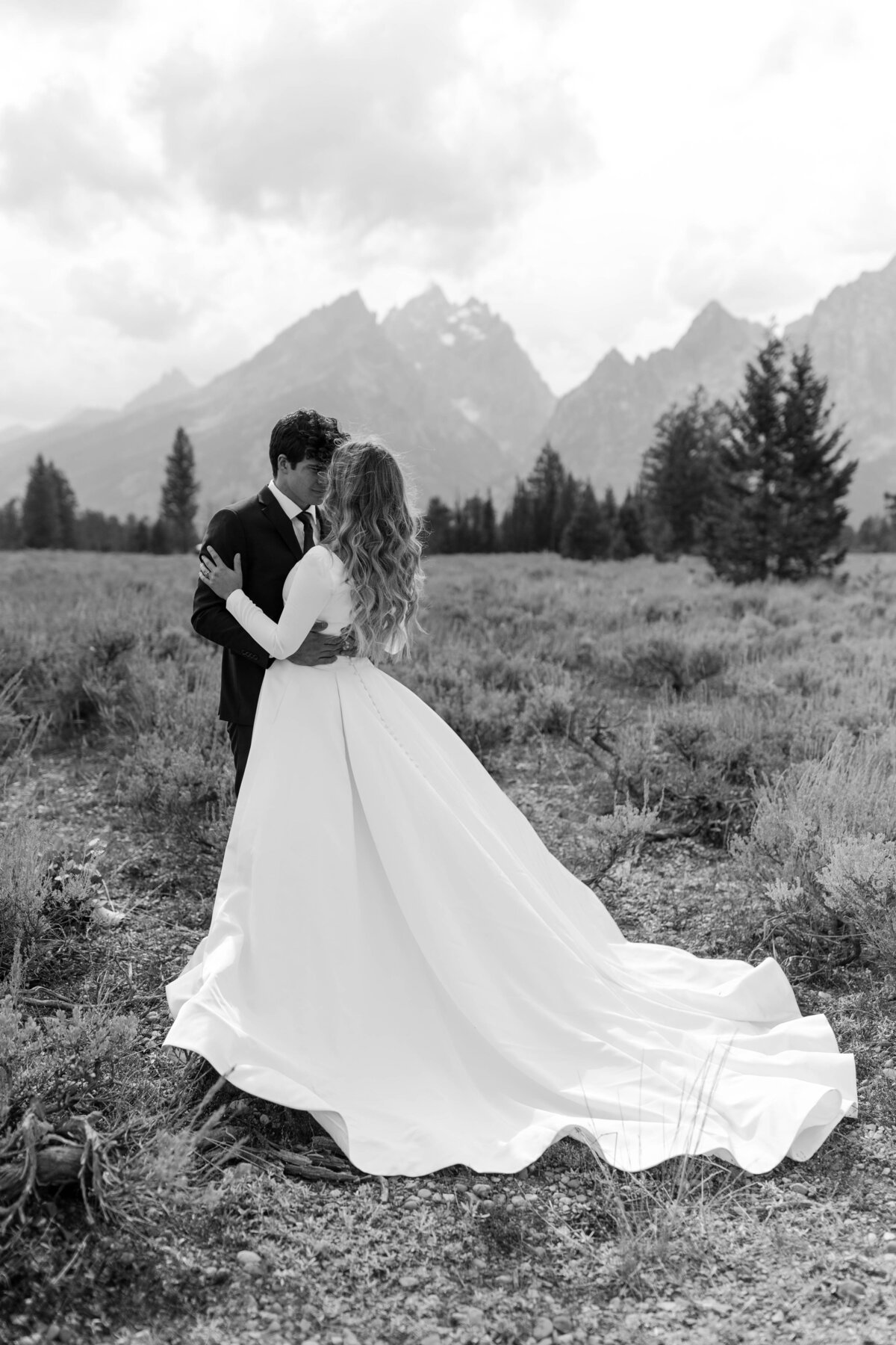 black and white image bride and groom kissing