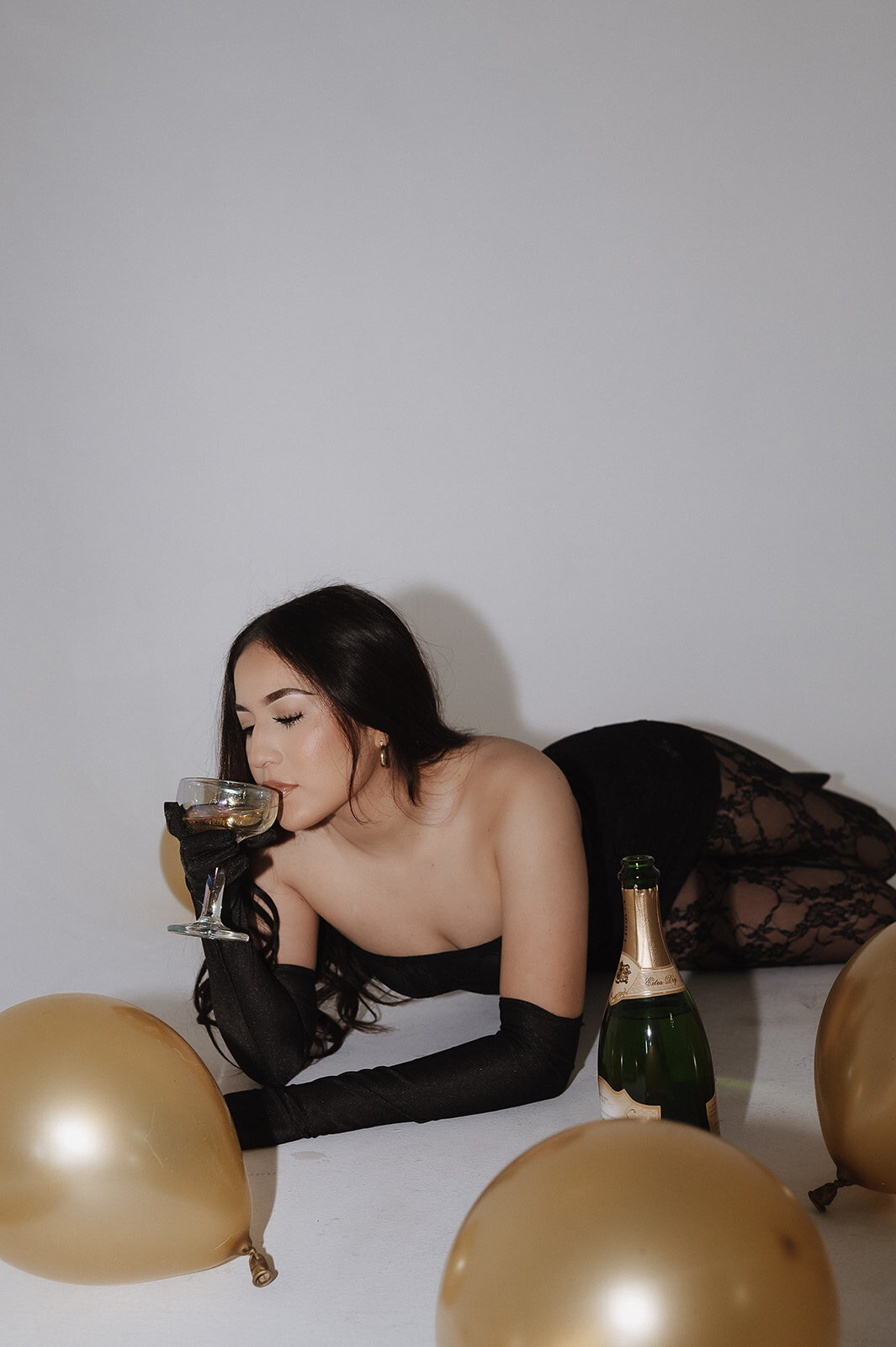 studio senior photo while sipping champagne
